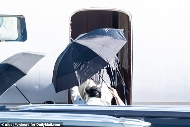 Taylor Swift returns to LA shielded by umbrellas after partying with
